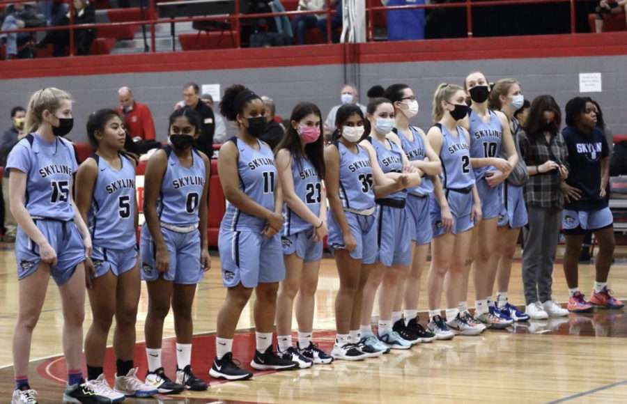 The Skyline Girls Basketball team lines up before a game. Credit: Skyline Yearbook