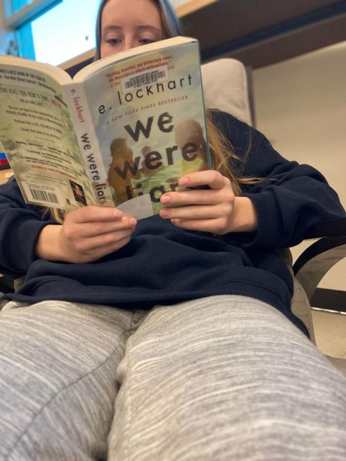 Student reading We Were Liars
