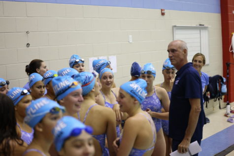 The Skyline swimmers and divers gather around Assistant Coach Paul Griffin at an early season duel meet. Credit: Jae Lee