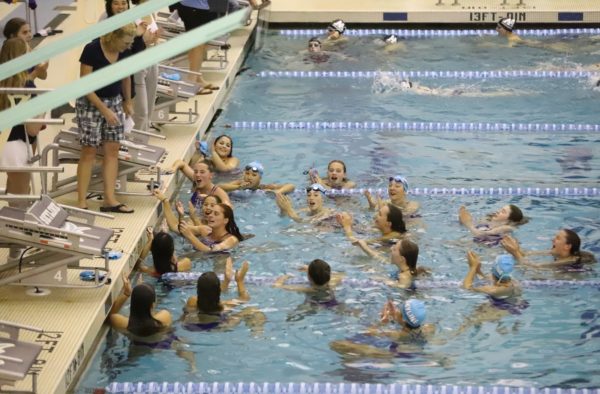 The Skyline Girls Swim and Dive Team gathers to listen to Head Coach Mo-Jo Murrett after their recent meet against Pioneer. Credit: Nicole McKelvey.