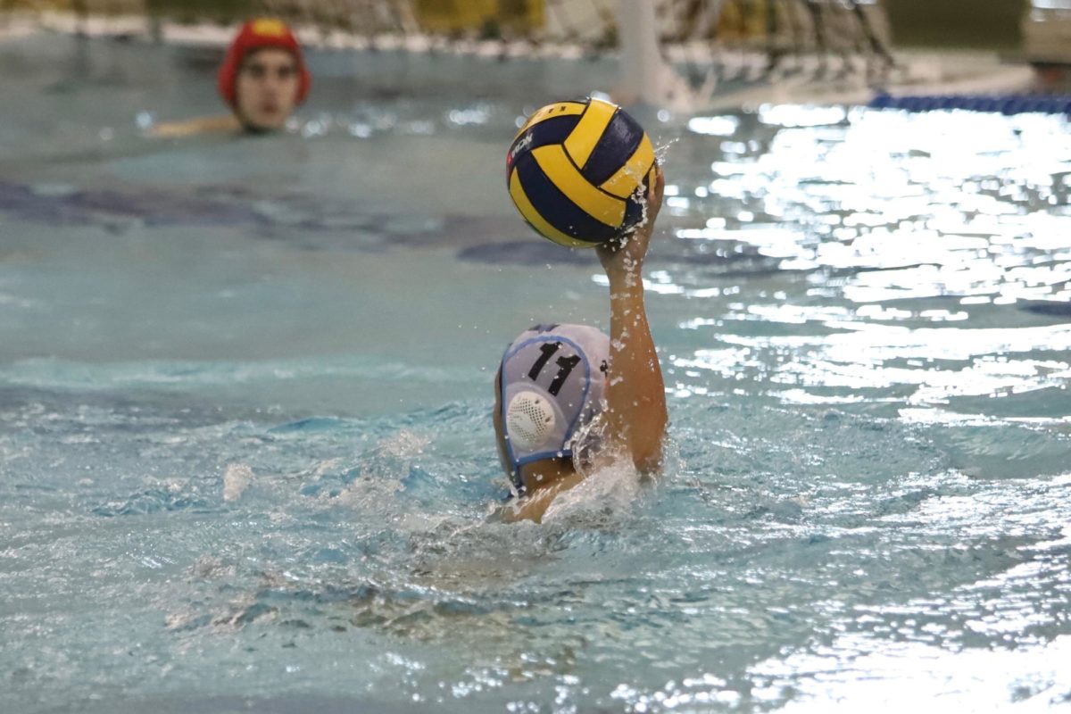 A Skyline Boys Water Polo player passes the ball to a teammate in their matchup against Groves High School at Regionals, a tournament which Skyline won in 2022. Credit: Nicole McKelvey.