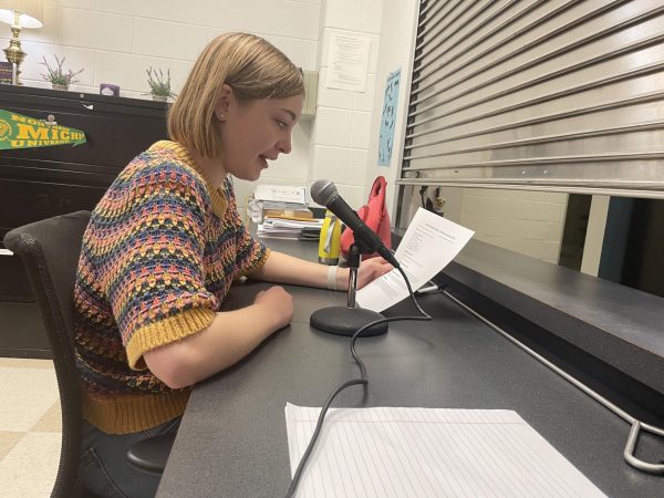Claire Hurley (26) reads the morning announclents over the PA system. Credit: Lucas Caswell.
