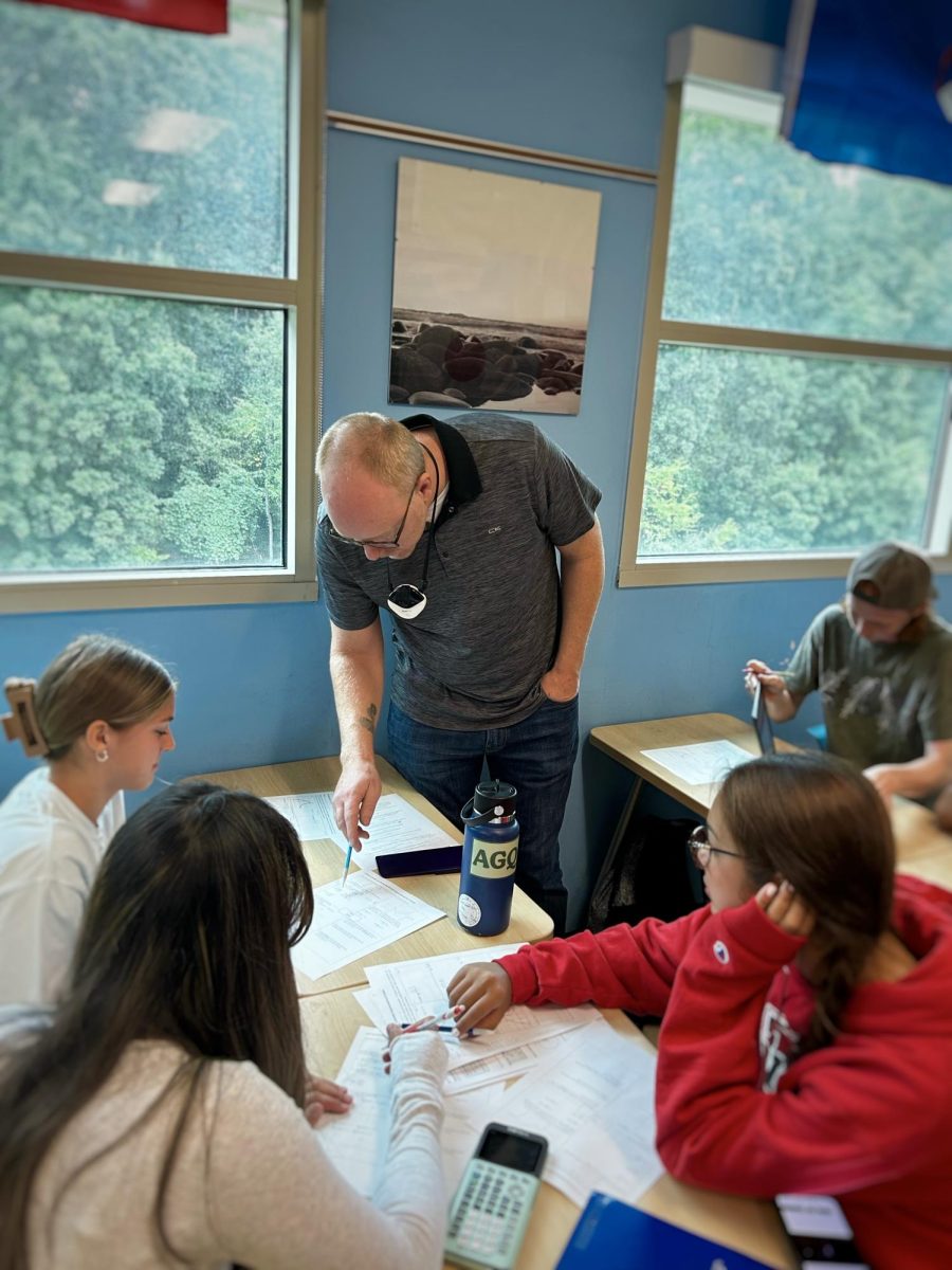 Mr. Oleksinski helps a group of students solve a complex limit problem. Credit: A. Repp.
