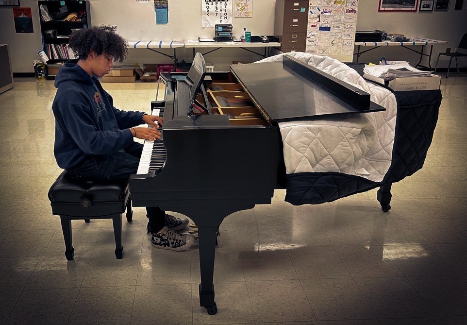 Emanuel Morrell-Weston (‘24) playing piano in the choir room. Credit: M. Feliks.