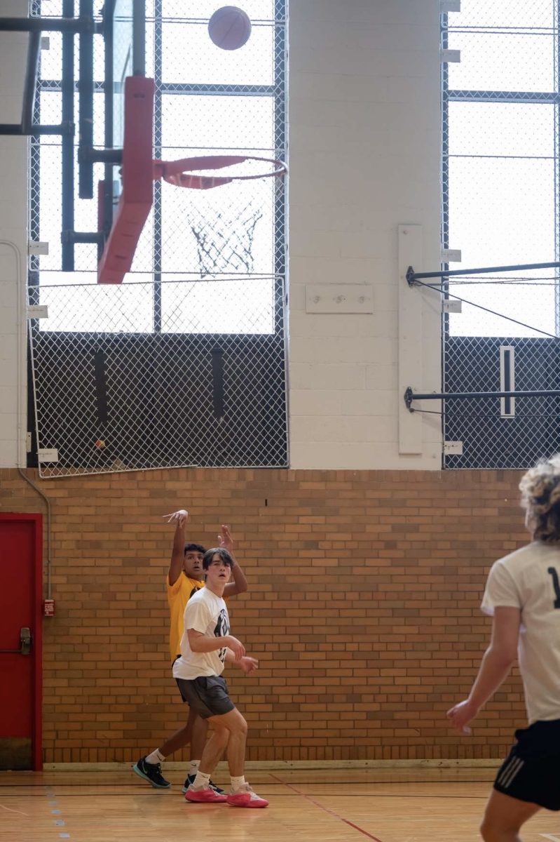 Nehith Kumar makes a shot over a defender.