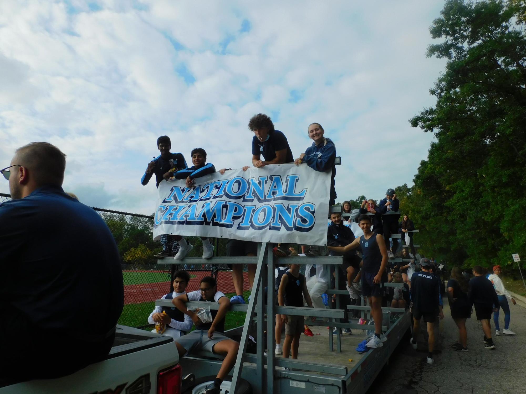Crew team holds banner in homecoming parade. Credit: Cecelia Brush.
