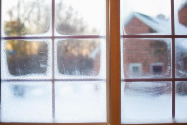 Frosted window overlooking the snowy outdoors. Credit: Creative Commons.