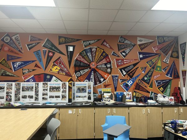 A display with various flags of college universities in the cube. Credit: A. Dawson.