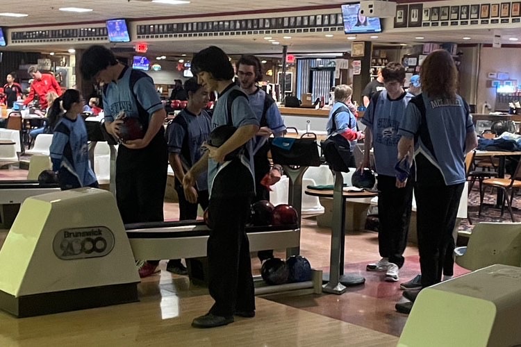 The bowling team preparing for a match. Credit: Rich North.