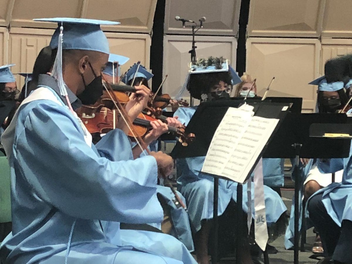 Kyle Foster (‘22) and seniors in orchestra playing at their graduation. 
