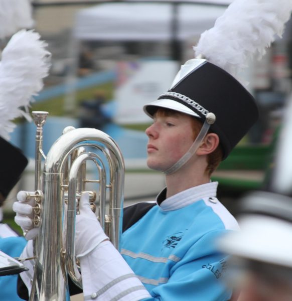 Thor Ham ('27) holds his marching instrument, the baritone, as he performs for the Homecoming game.