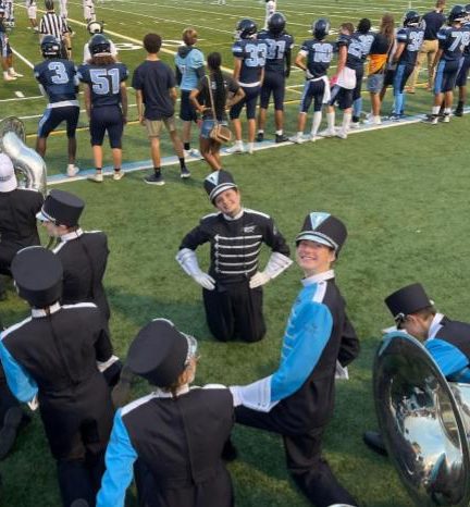 Drum Major Maxine Rosaen ('26) waiting behind the sidelines, ready to lead the Skyline Marching Band's halftime performance.