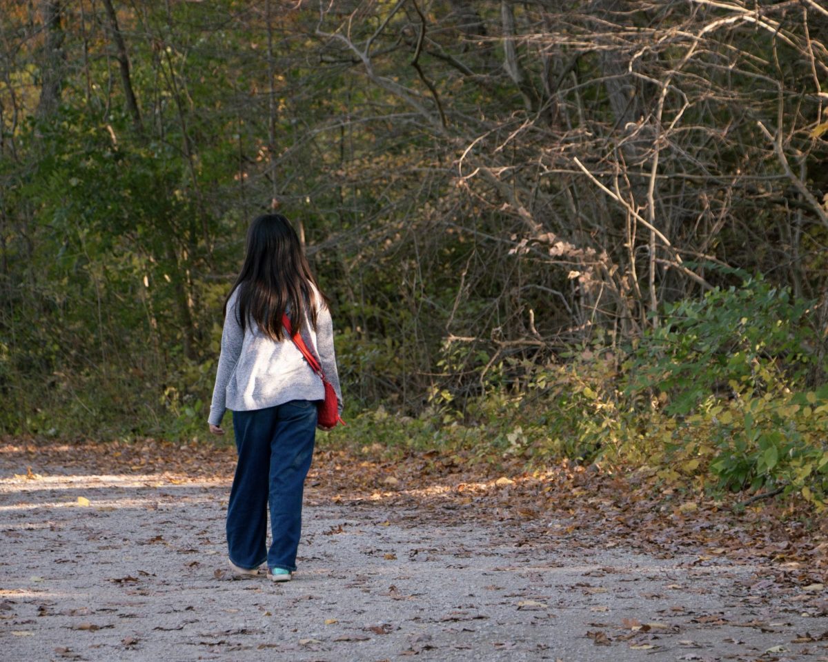 A girl takes a walk through Nichols Arboretum.