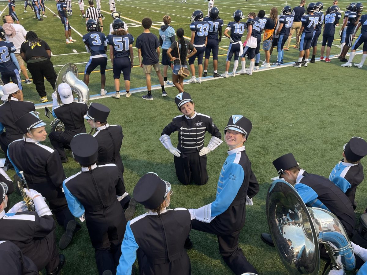 Drum Major Maxine Rosaen ('26) waiting behind the sidelines, ready to lead the Skyline Marching Band's halftime performance.