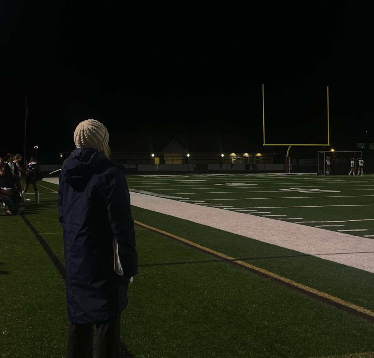 Field Hockey Head Coach Shelby Fulkerson guiding her team during a game.