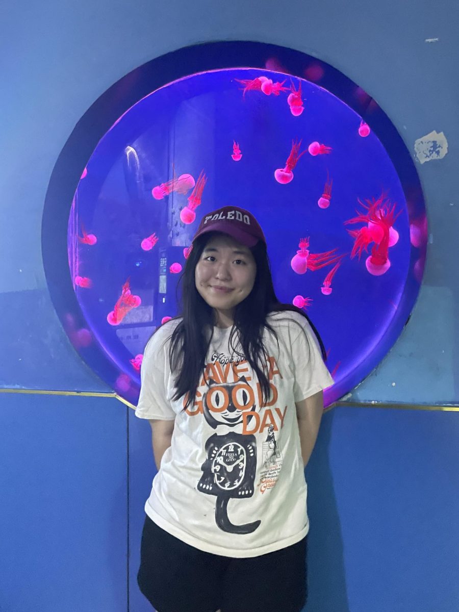 Ashley Han standing in front of a jellyfish tank in China. (Li Yan) 