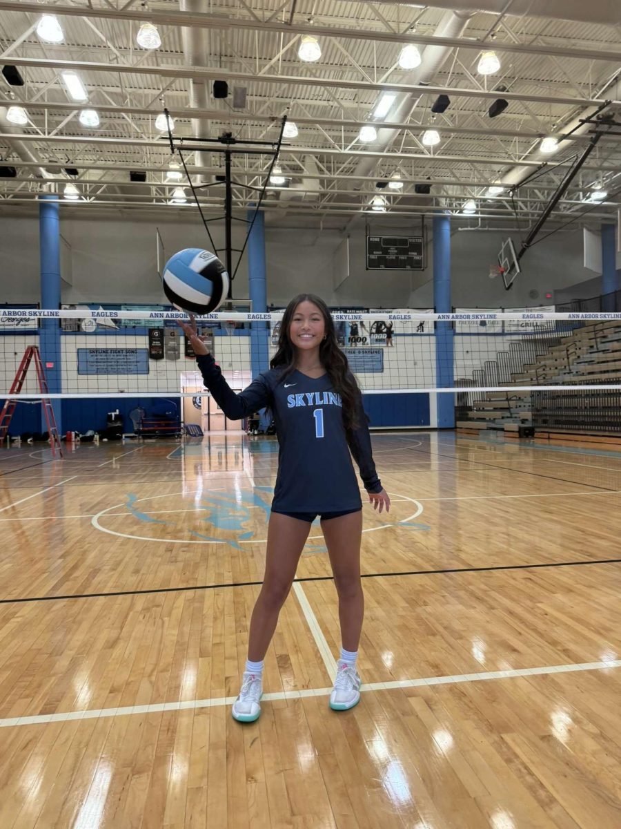 Allison Lee ('28) posing for media day with a volleyball.