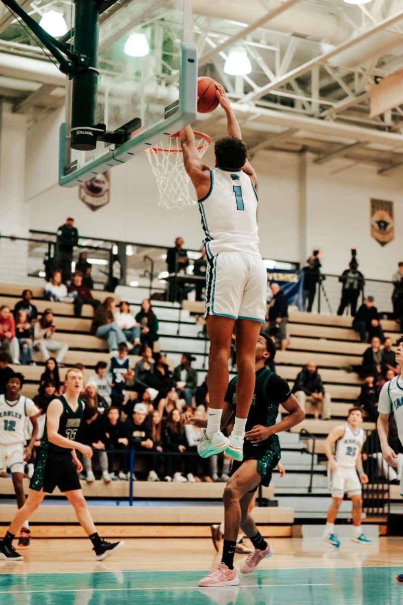 Noah Silkworth dunking during a basketball game.