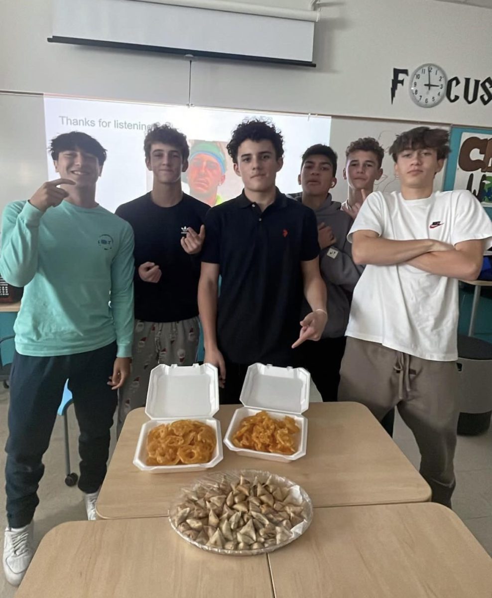 Members of the World Cuisine Club before eating an authentic dish.