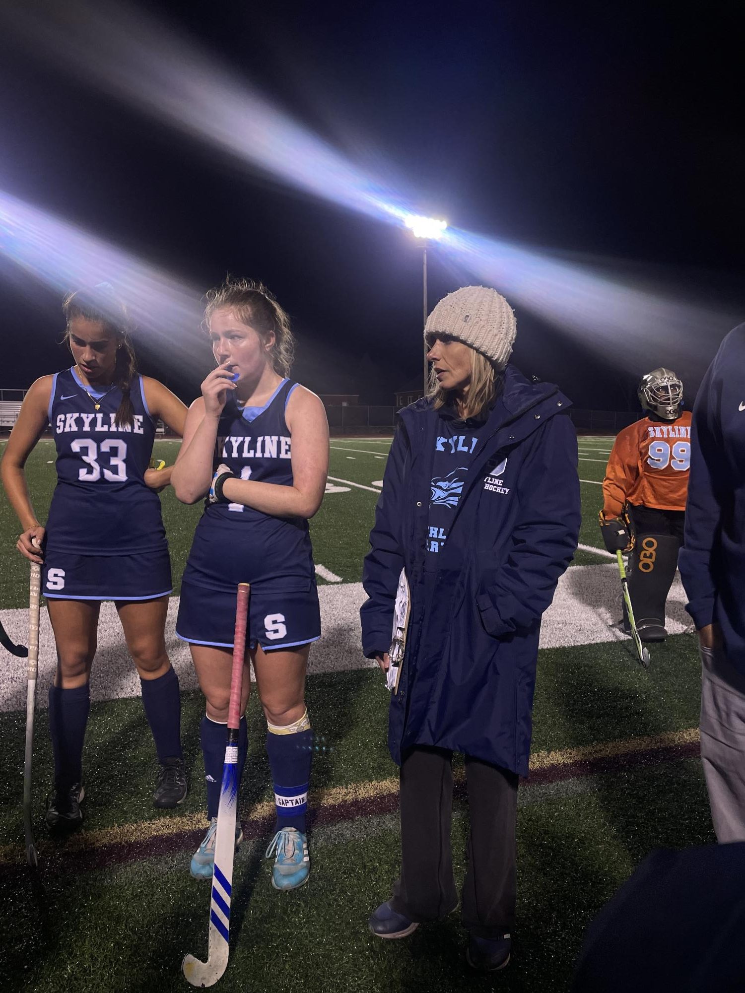 Coach Shelby Fulkerson giving an encouraging halftime speech during a big game. 