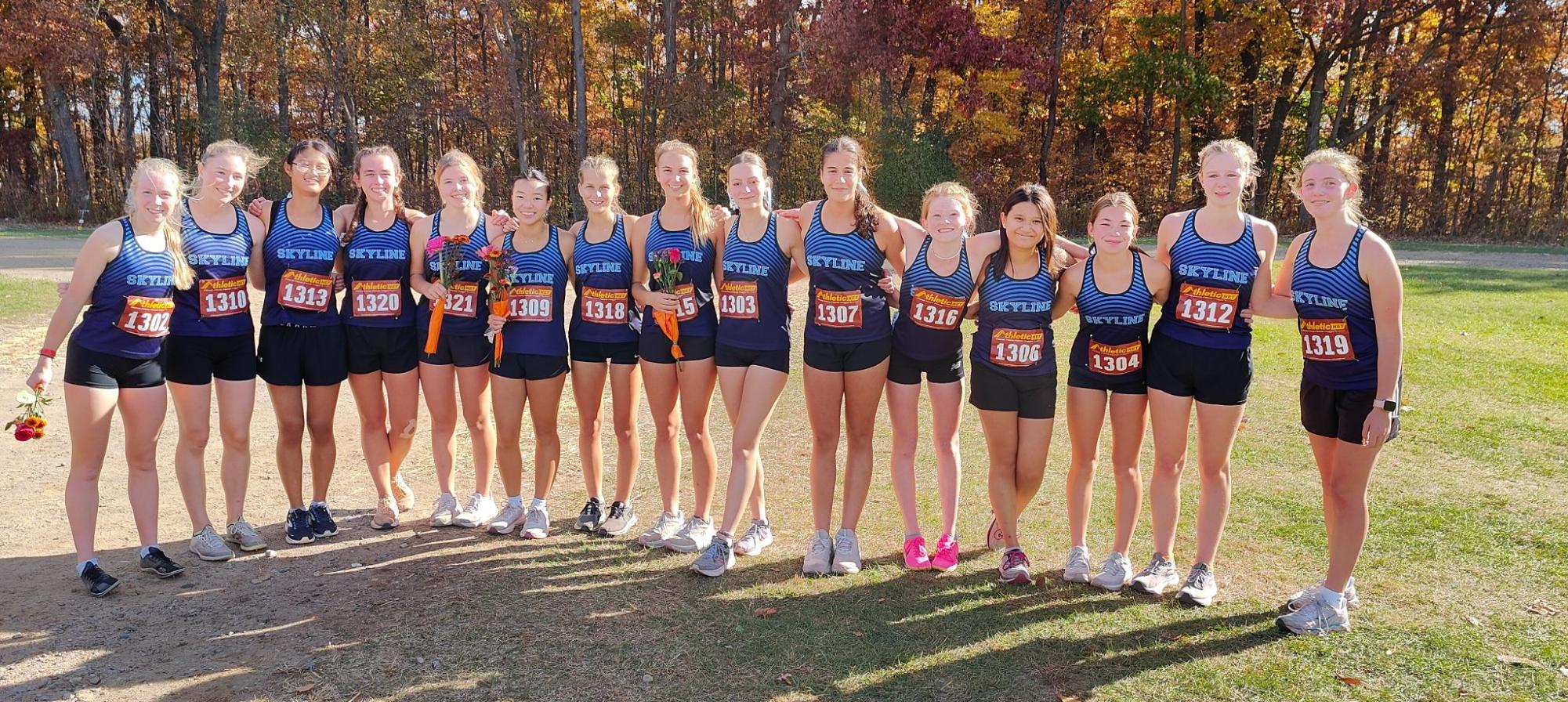 Skyline Girls' Cross Country Team lines up to snap a photograph after their 2024 District meet races. 