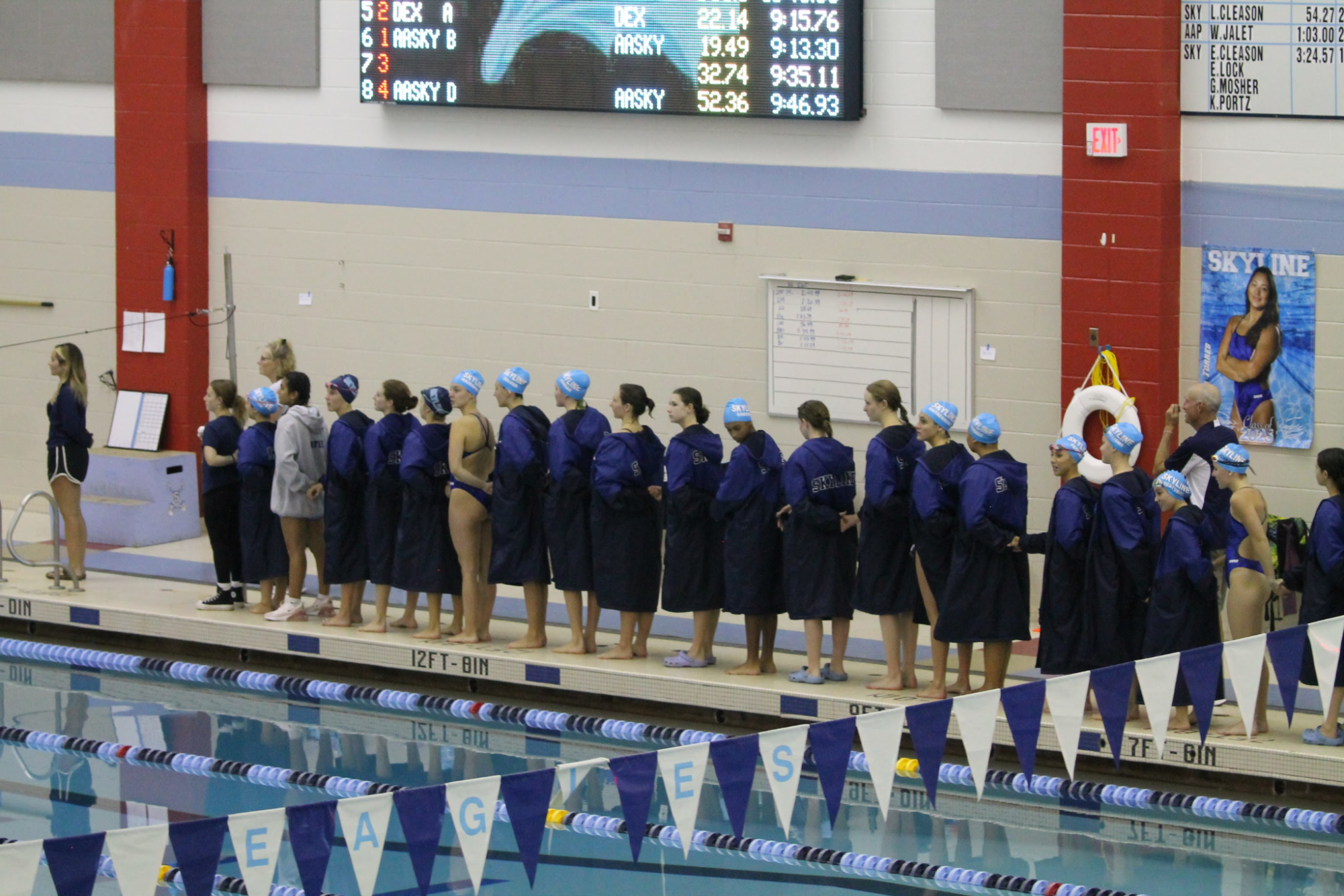 Skyline Swim lines up for the national anthem before winning their meet against Huron.