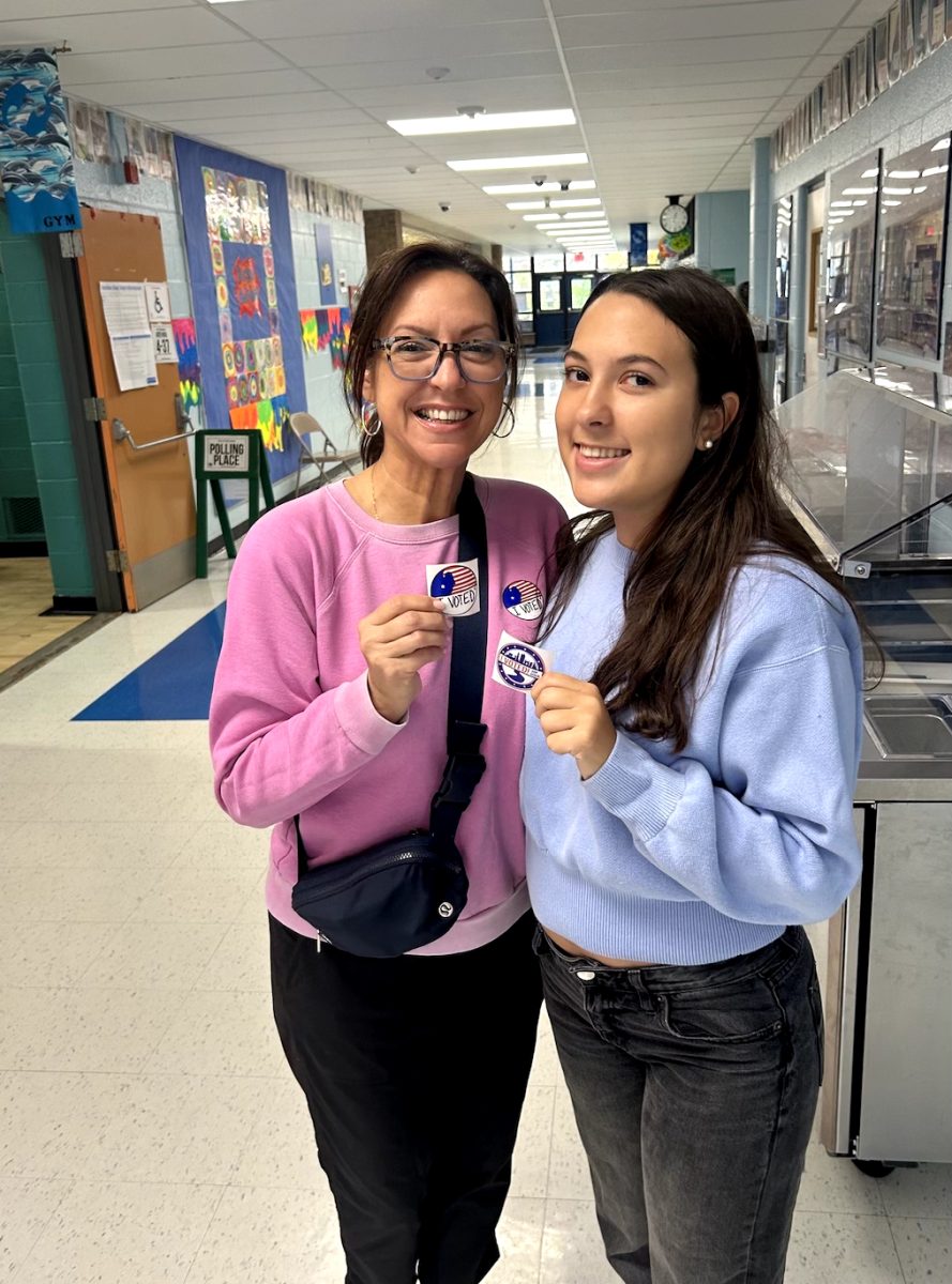 Nati Murrell ('25) and her mother smiling after voting in their neighborhood.