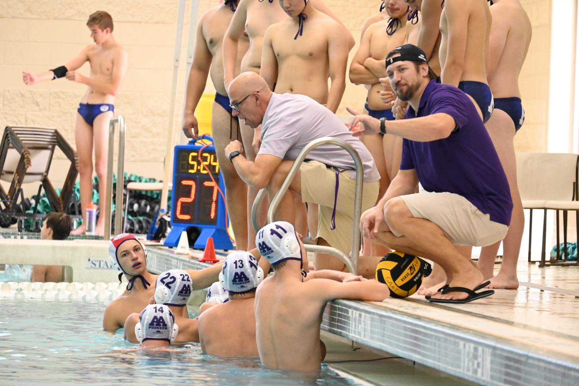 Coach Don Packard rallying up the team during intermission. 
