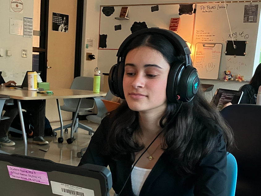 Student M. Banerjee ('28) listening to music while studying.