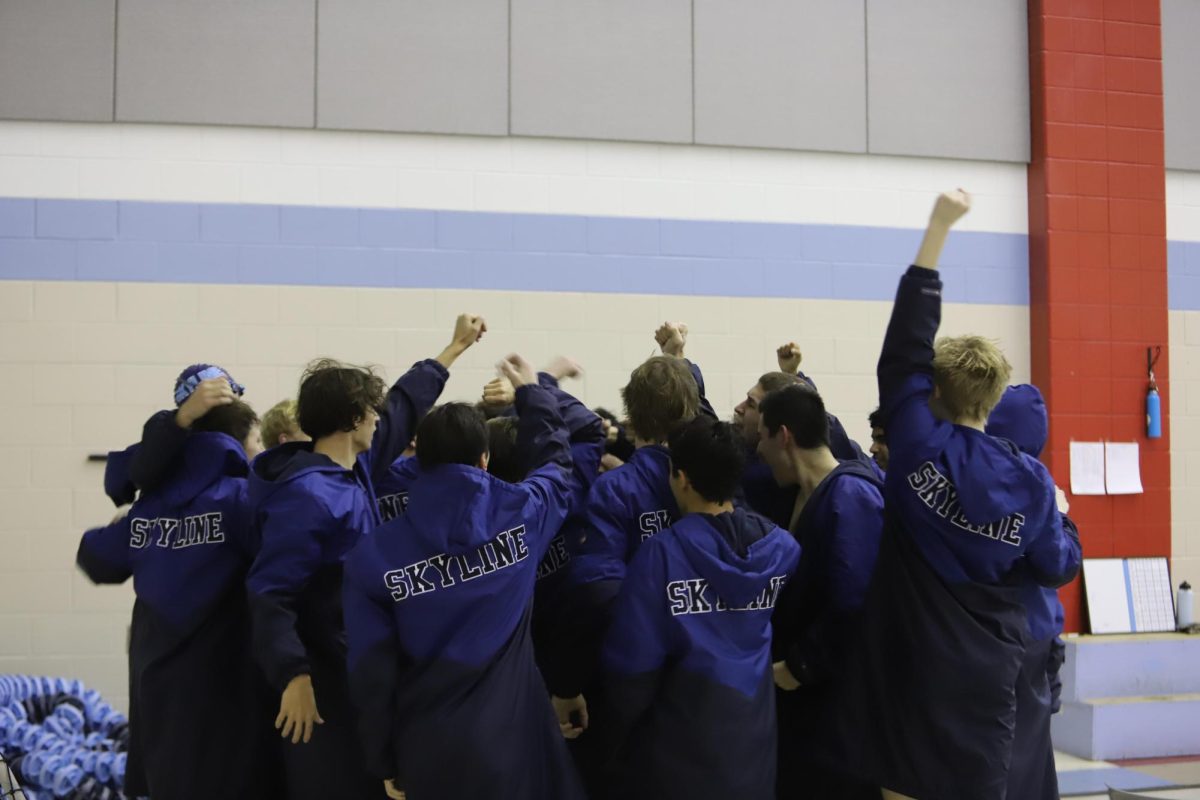 Men's Skyline Swim and Dive performing their cheer during a home meet against Brighton.