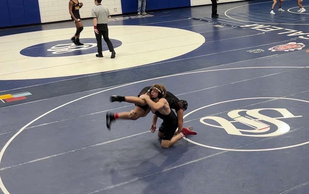 Connor Gillilland ('25) takes down an opponent during a wrestling match. 