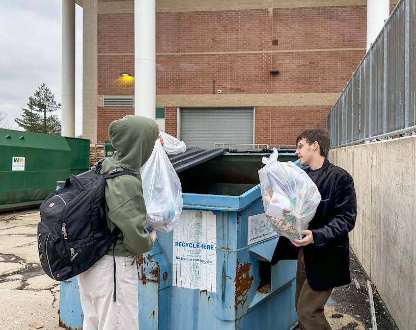 ESC Labor Group Leader Kai Jellings (‘26) and Skyline alumnus Ian Schleick (‘24) empty bags of recyclables into the school’s recycling bin.