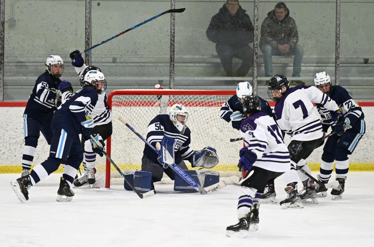 Skyline and Pioneer fighting for the puck near Skyline's net.