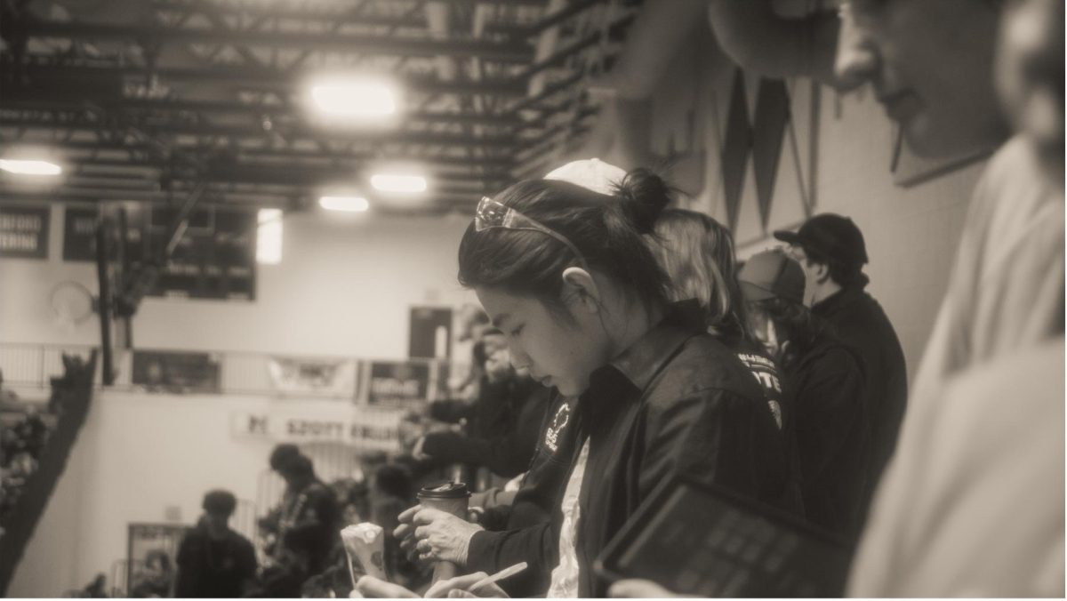Sean Meng (26') watches as the robots compete, photographed by Joowon Lee.