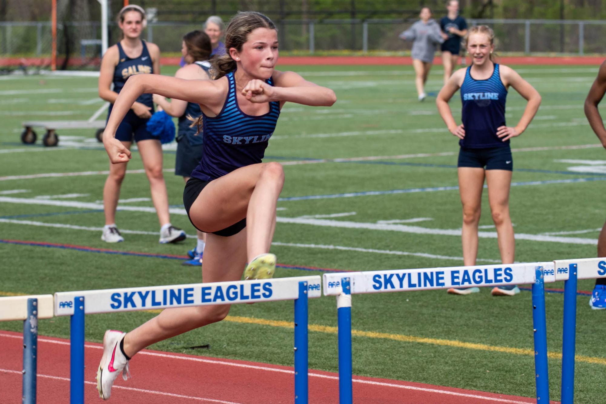 Tynne Hannahs (’27) leaps over a hurdle to win the event and secure a new school record.