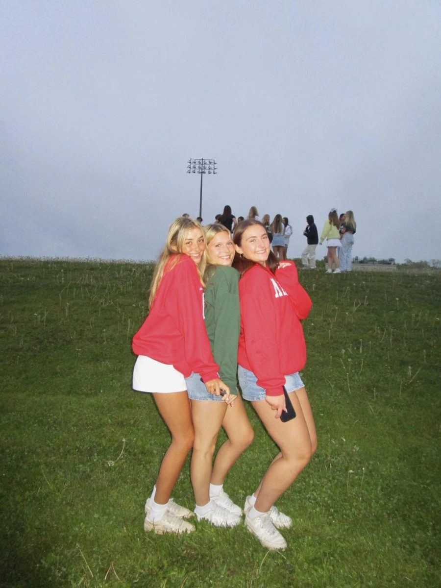 Seniors Sydney Harwick ('25), Mia Yaeger ('25), and Marisa Moe '25 taking senior sunrise photos.