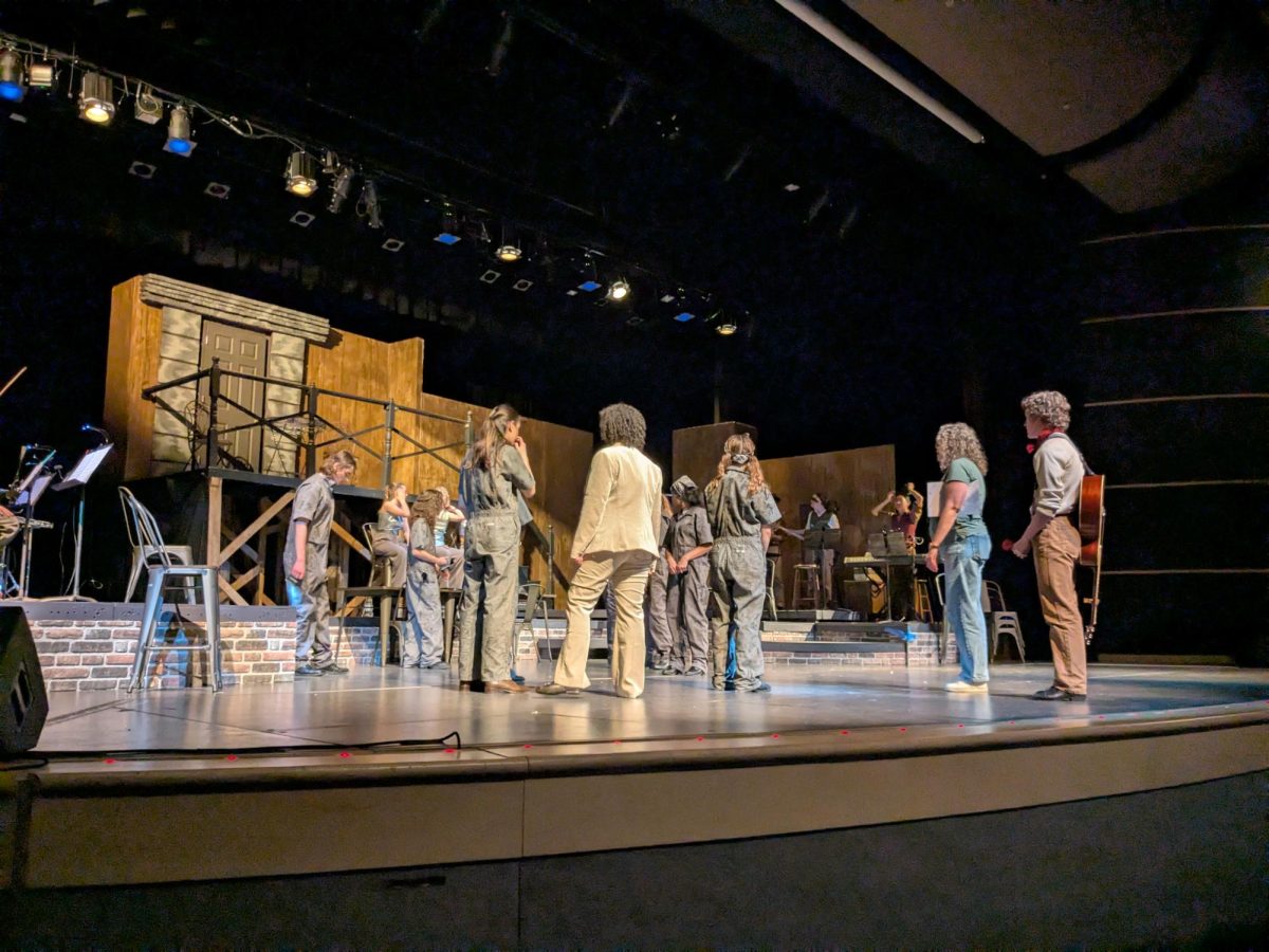 Anne-Marie Roberts leads blocking for Will Powers (‘26) and the Workers ensemble.