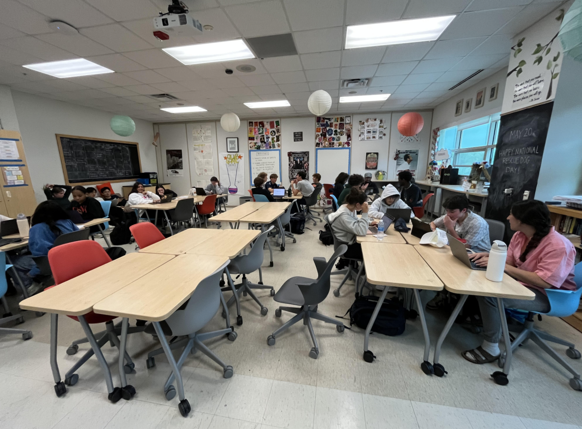 AP Lang students gather and converse on personal essays.