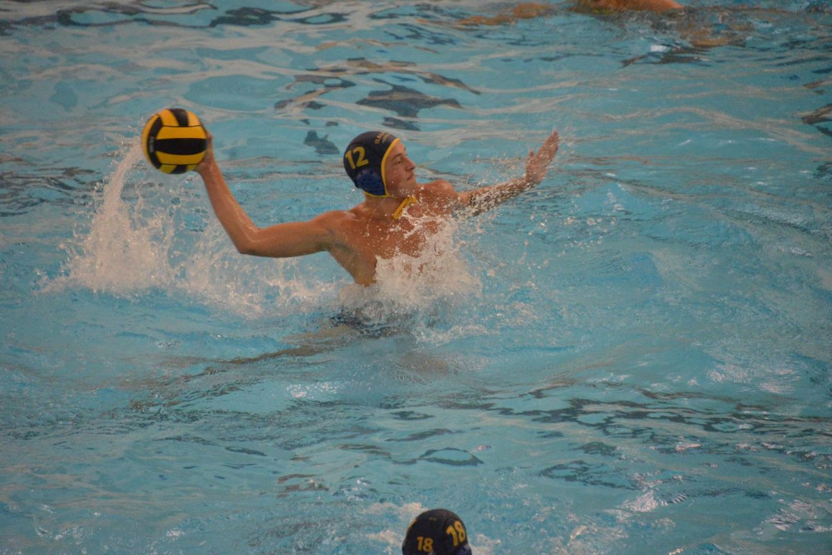 Sean Spooner ('26) grips the ball as he goes for a shot against Upper Arlington.