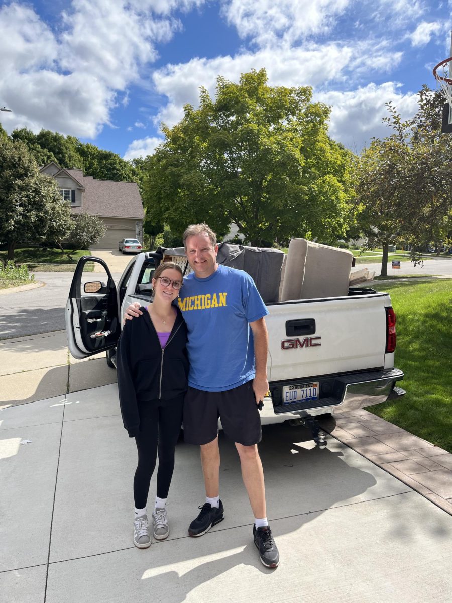 Mike Lovelace and his daughter moving couches.