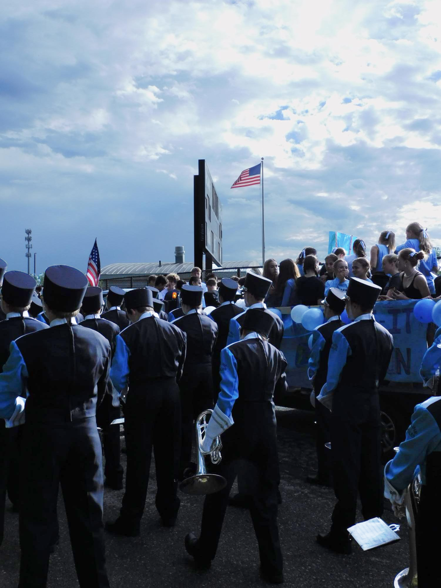 Skyline marching band members prepare for their performance in the 2024 Homecoming parade.