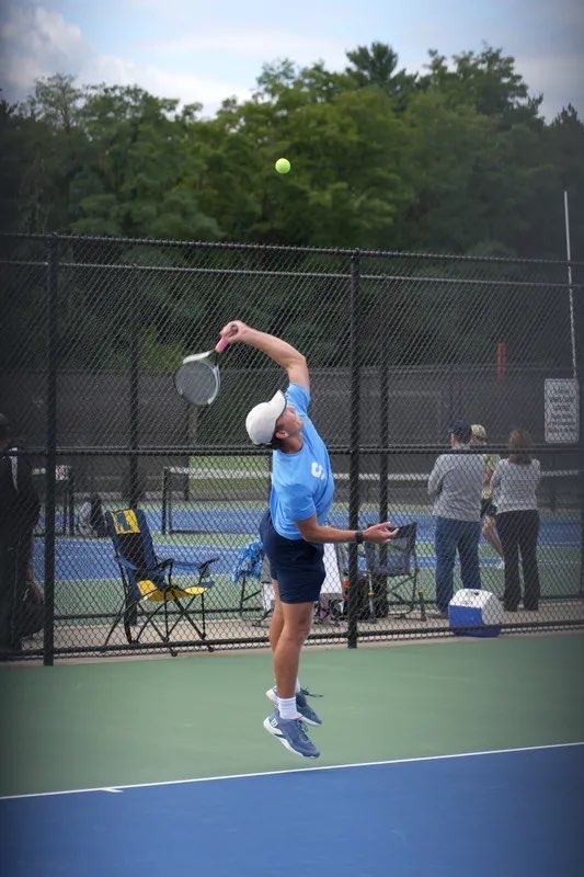 Connor Wilcox ('26) serving during a match