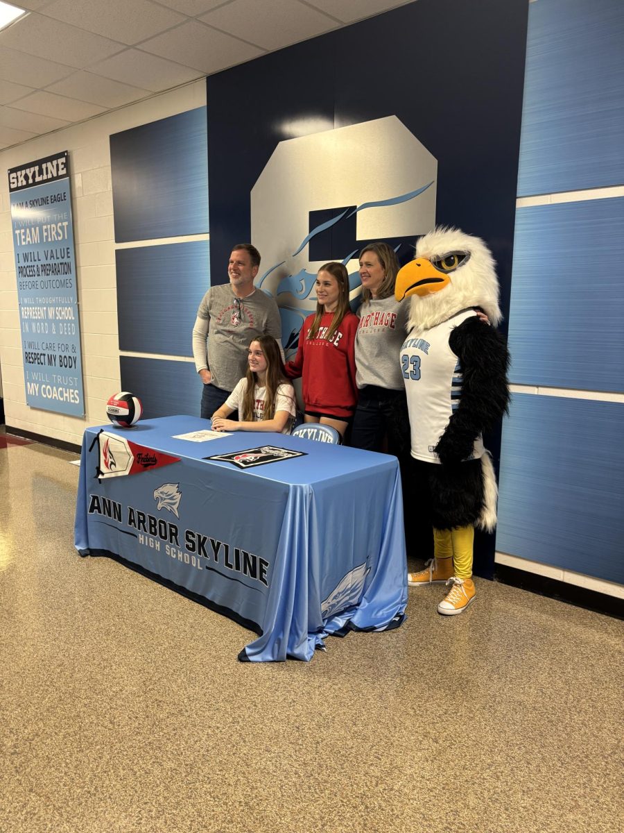Senior Athlete poses with family after signing to continue her career at Carthage College