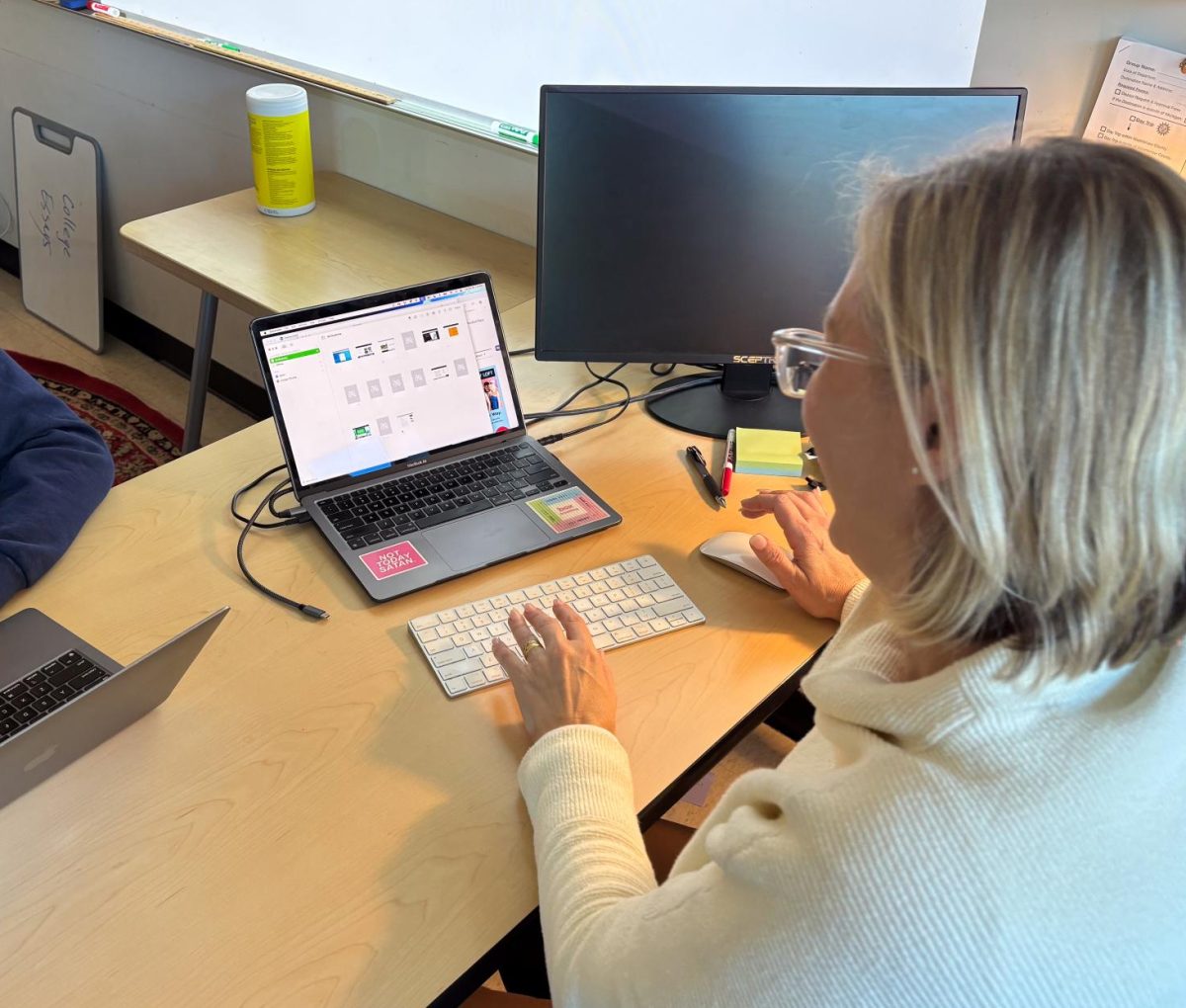Dr. Blais using apple classroom to watch her students.