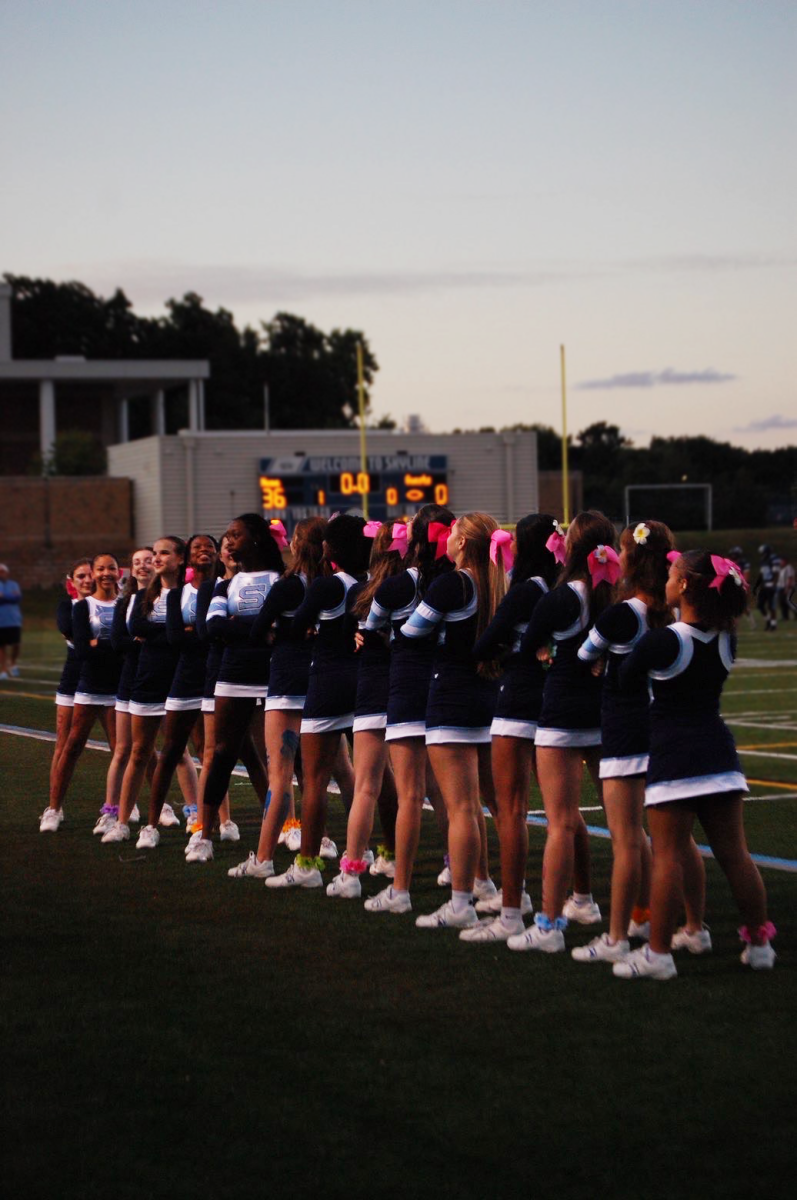Pom forming their starting position for their high kick.