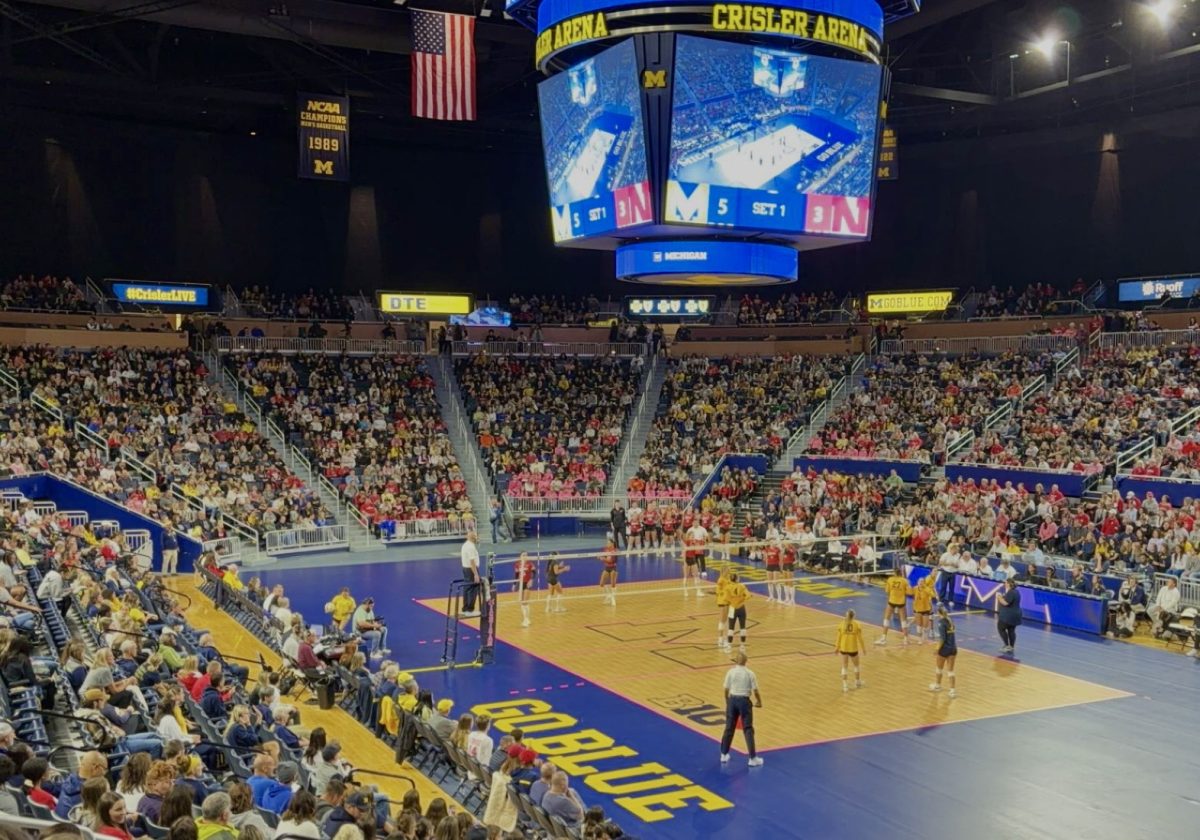 Michigan and Nebraska volleyball competing against each other.