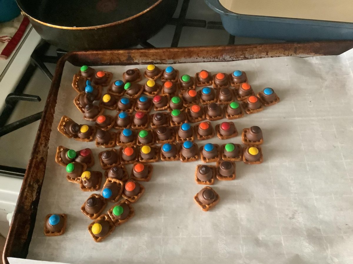 Square pretzels with Hershey's kisses and M&Ms on top.
