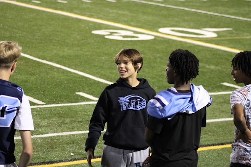 Micheal Kauffman taking pictures on the sideline of a skyline football game