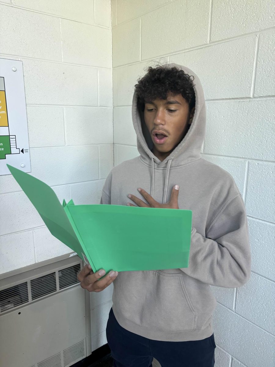 Lathan Nundley ('29) sings sheet music for Skyline Choir.