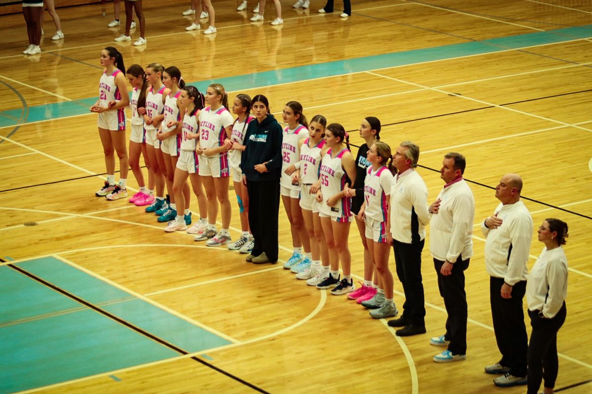 Girls Basketball team standing together for the pledge of allegiance 